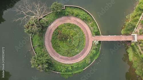 Fotografi Aerial view of a circular pathway and garden on a small island in a body of wate