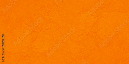 Vintage grunge orange wall texture with a rough aged paper pattern and dirty yellow surface design for a blank canvas background material