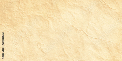 Abstract light orange textured paper background with organic parchment crinkle and soft vintage stone wash effect