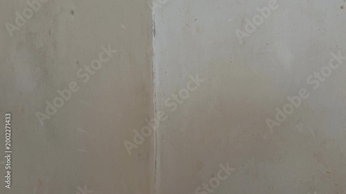 Worn concrete wall with weathered texture, suitable for use as a background in various projects