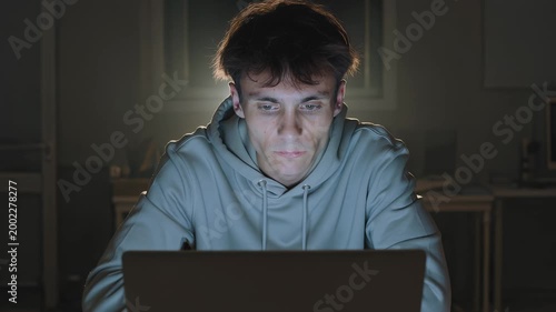 Young Man Working Late on Laptop.