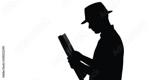 Silhouette of a man in a hat reading a book with focused attention on the pages