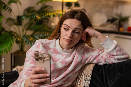 Photography Middle-aged woman at night home scrolls smartphone news feed bored tired stressed demotivated