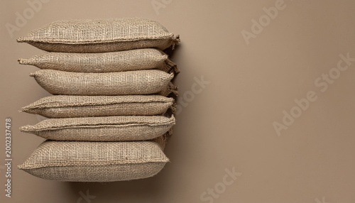 Earthy stack of burlap sacks on a neutral background, conveying organic textures