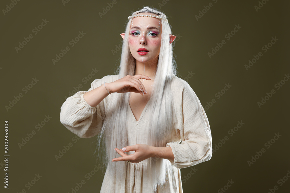 Fototapeta premium Beautiful elf girl on dark olive background