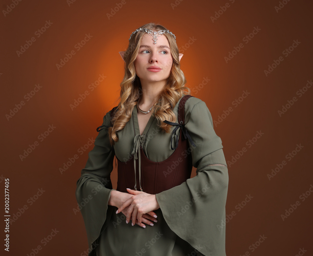 Fototapeta premium Beautiful elf girl on brown gradient background, space for text