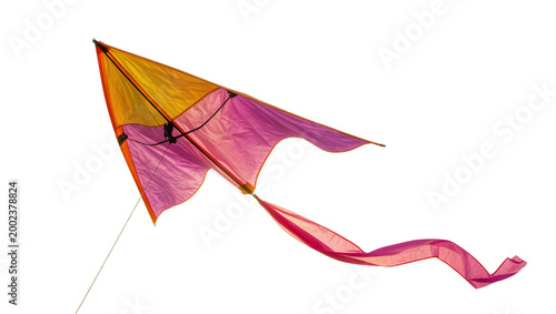 Fotografie Isolated vibrant colorful kite with flowing pink and orange tail against a clear