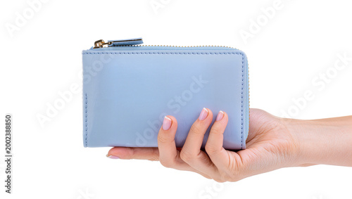 Konstfotografi Isolated fashionable light blue small wallet held by a woman's hand, close-up sh