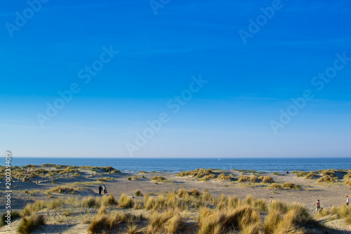 Dunkirk beach, Plage Dunkerque, promenade near the sea, coastline, sand, dunes, Malo-les-Bains, France, La Manche, people walking far away, a large beach known from the Second World War