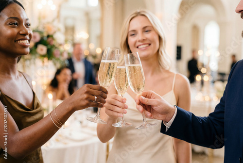 Diverse friends cheerfully toasting champagne at a festive social event