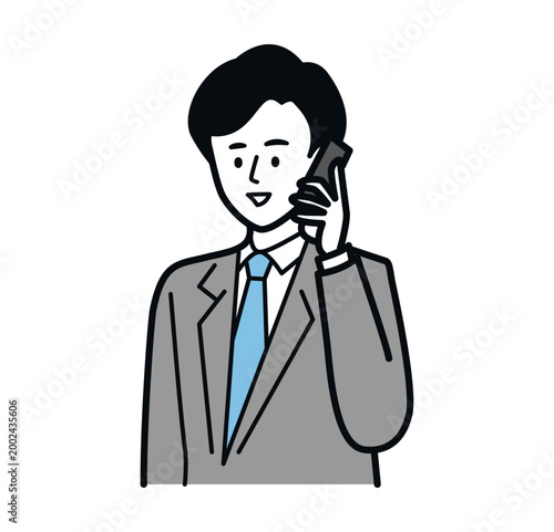 スマホで通話するスーツ姿の若い男性