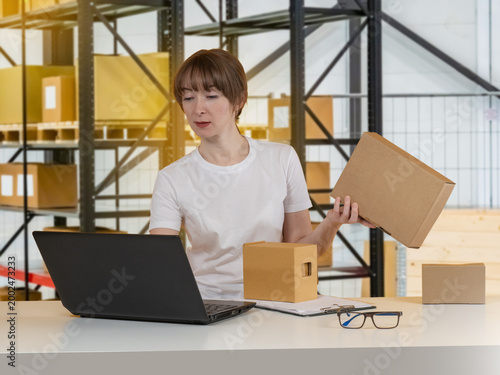 Warehouse clerk checks parc...
