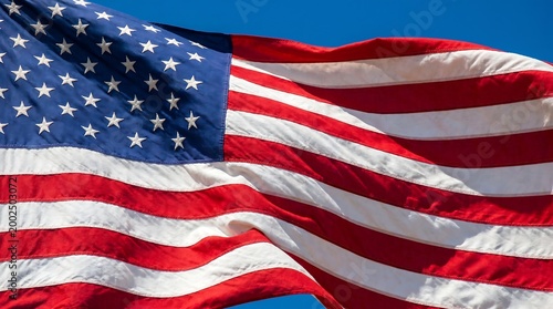American flag waving proudly against a clear blue sky background.