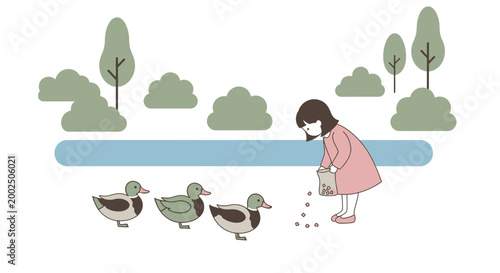 Little girl feeding ducks outside.