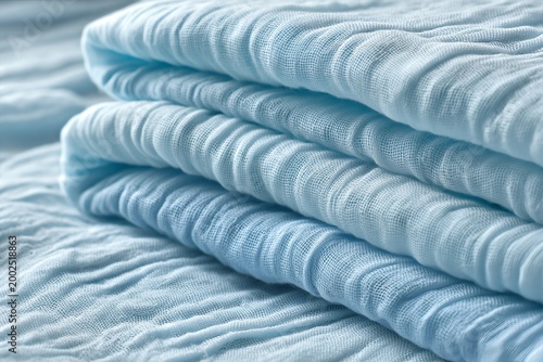 Light blue seersucker cotton fabric texture with soft ripples and folds for summer textile