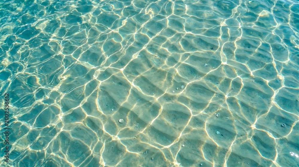 Fototapeta premium Turquoise ocean surface with sunlight ripples and aquatic vibe