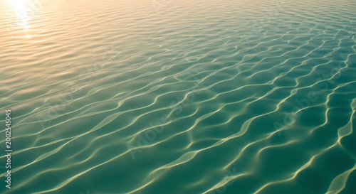 Calm ocean water, sea surface, ripples at sunset, serene aquatic background