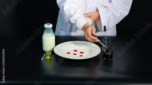 Foto Person in Lab Coat Preparing Color Explosion Milk Science Experiment