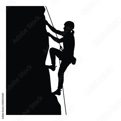 Silhouette of woman rock climbing wall.