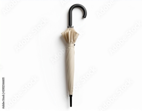 Closed beige umbrella with black handle on white background