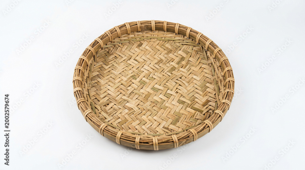 Fototapeta premium Woven bamboo plate on white background.