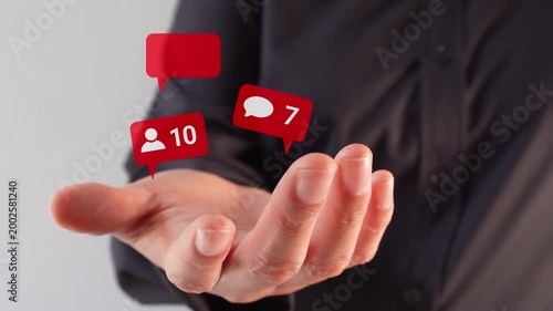 Close-up of a businesswoman's hand holding an animation of friend notifications, hearts, and messages with a counter. Social Media Interaction