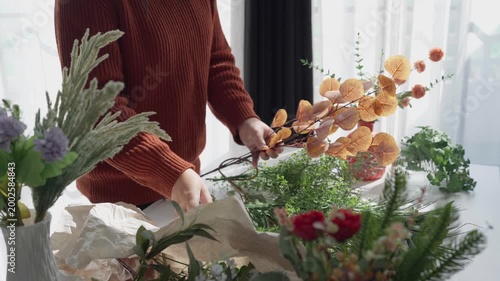 Flower shop owner arranging flowers