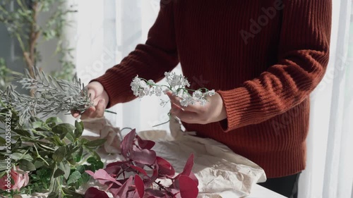 Flower shop owner arranging flowers
