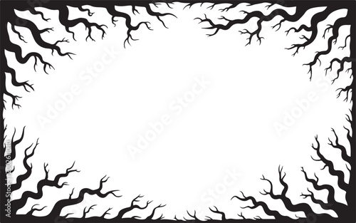 A dark frame formed by eerie bare tree branches with a spooky Halloween atmosphere