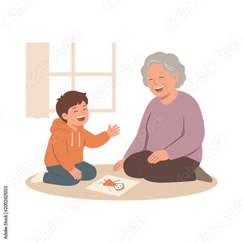 A young boy and elderly woman sit on a mat indoors, smiling and engaging with a puzzle.