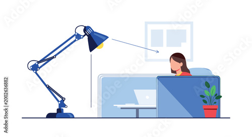 Young female professional working on laptop at modern office desk under bright task light focusing on business tasks and productivity.