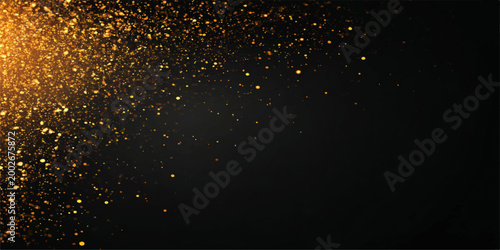 Luminous water drops on a dark glass texture create a bright galaxy of gold particles glowing like stars in the night sky