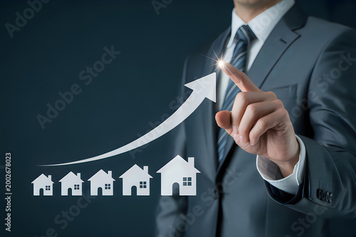 Businessman pointing at a rising arrow graph with house real estate growth concept