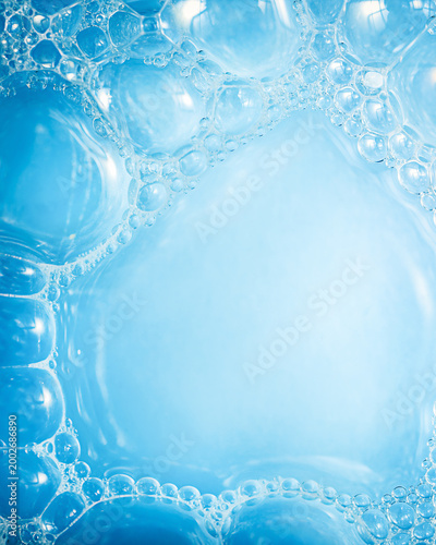soap foam background that creates a soft blue hue, made of many transparent bubbles of different sizes, used as a background image for web design or presentations.