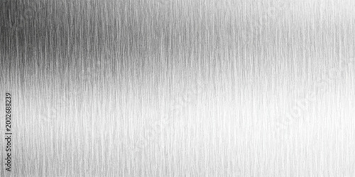 A textured, seamless expanse of brushed metal. The smooth, shiny metal surface reflects light with subtle gradients, creating a dynamic play of light and shadow.
