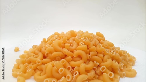 Elbow Macaroni Pasta Dropping on White Background, Uncooked Elbow Macaroni Pasta Ingredient