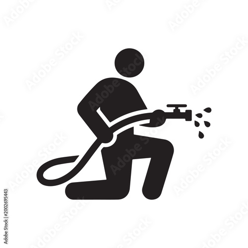 Person Kneeling While Using a High Pressure Water Hose with Nozzle Spray.