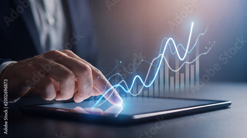 Fotografie Close-up of a businessman's hand interacting with a digital tablet