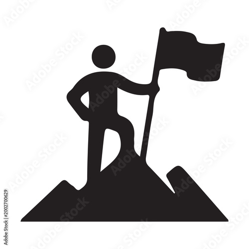 man standing on mountain peak with flag in hand triumphantly waving it