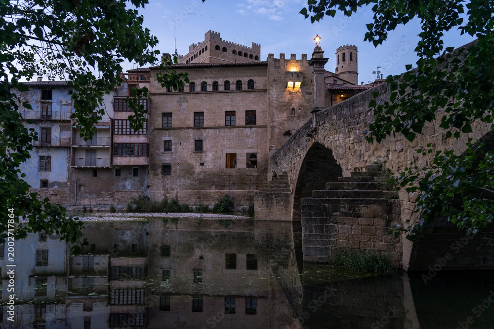 Fototapeta premium VALDERROBRES, SPAIN - JULY 02, 2025: Panoramic view of the beautiful village of Valderrobres, in the Matarraña zone, at night. Teruel, Aragon, Spain.