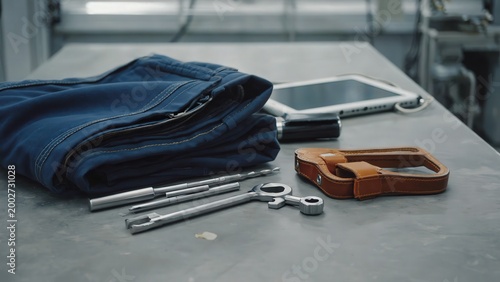 Folded workwear with tools on bench