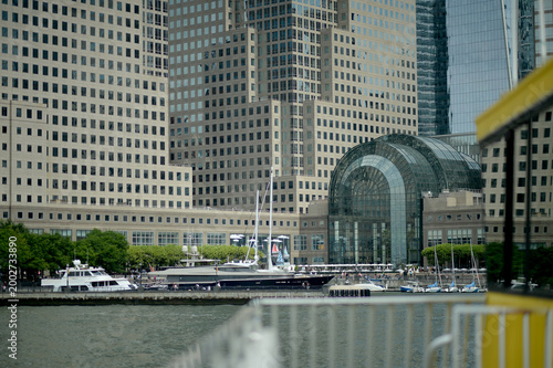 Sunrise Illuminates Peaceful River As Boats And Pedestrians Enjoy Vibrant Harbor new york
