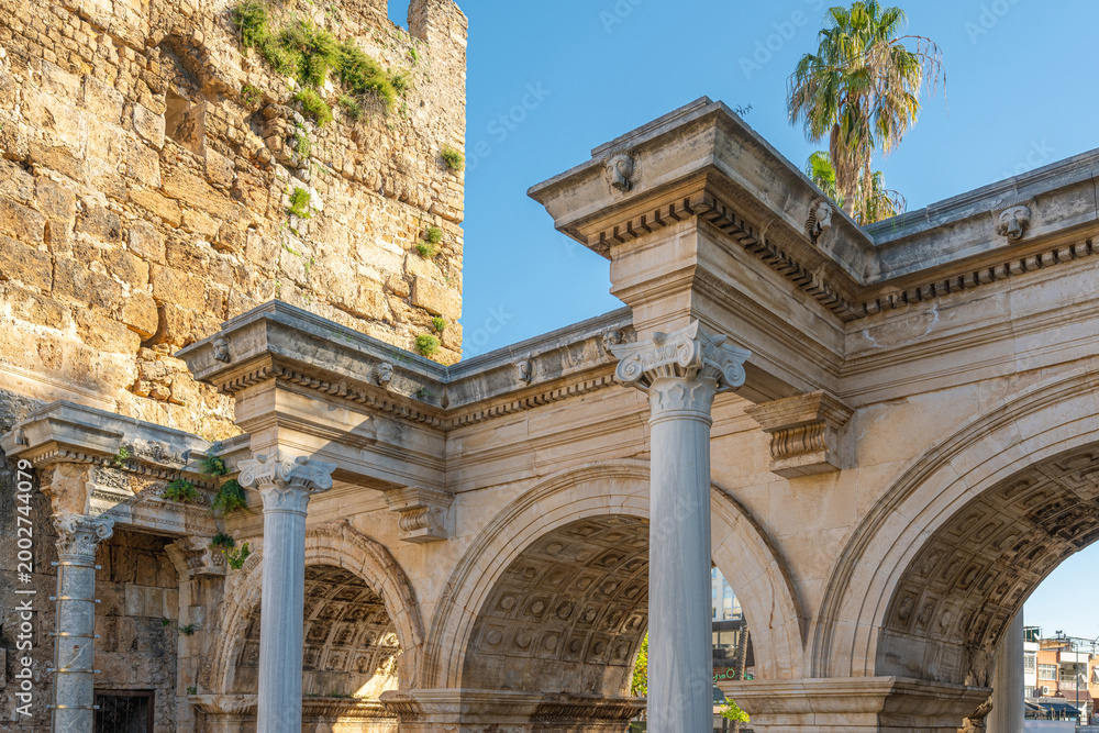 Fototapeta premium Hadrian Gate in Antalya Old Town Kaleici with palm tree under blue sky