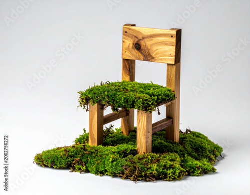 Miniature chair covered in green moss