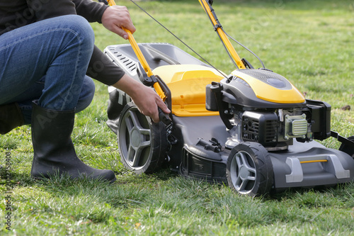 Adjusting Lawn Mower Cutting Height – Close Up of Grass Cutting Preparation and Maintenance