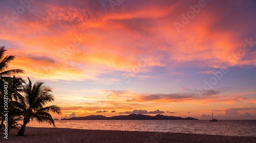 Vibrant tropical sunset over ocean.
