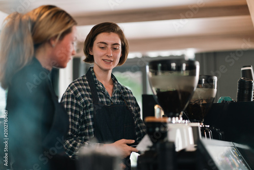 Coffee shop worker serving ...