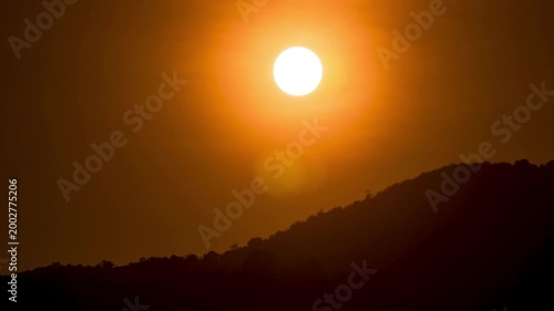 Mountain sunset time-lapse with flowing mist and golden hour light hitting the ridges.