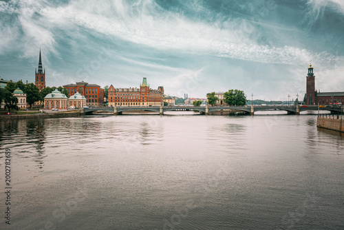 The Vasa Bridge to Gamla stan over Norrstrom, with the Riddarholmen Church tower in the back in Stockholm, Sweden. Riddarholmskyrkan church and historic waterfront skyline, Stockholm, Sweden