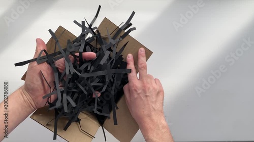 cutting paper with scissors. Black paper. Shredded paper. slow motion video. High quality 4K footage